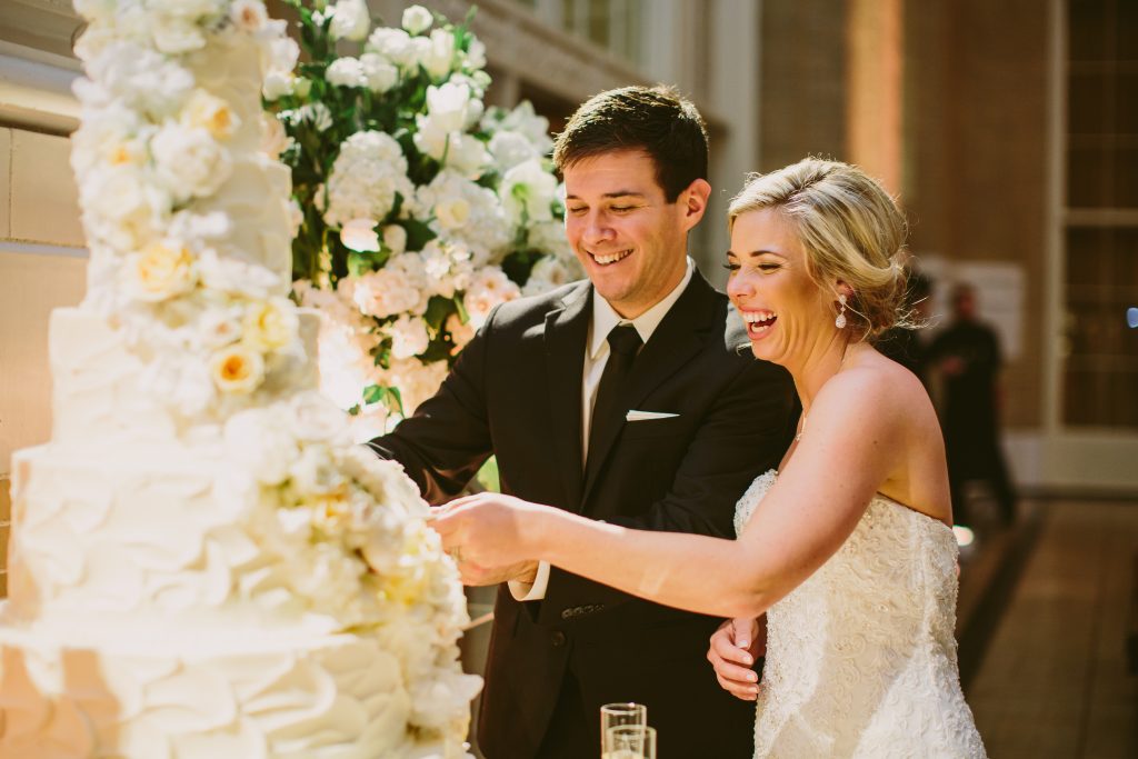Happy couple cut wedding cake
